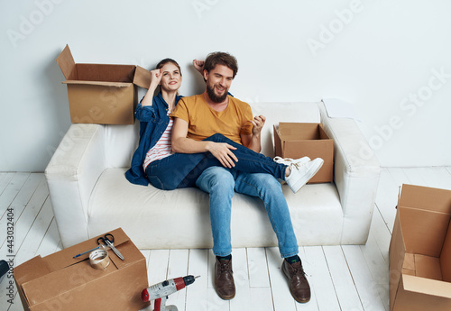 cheerful married couple boxes with things moving fun