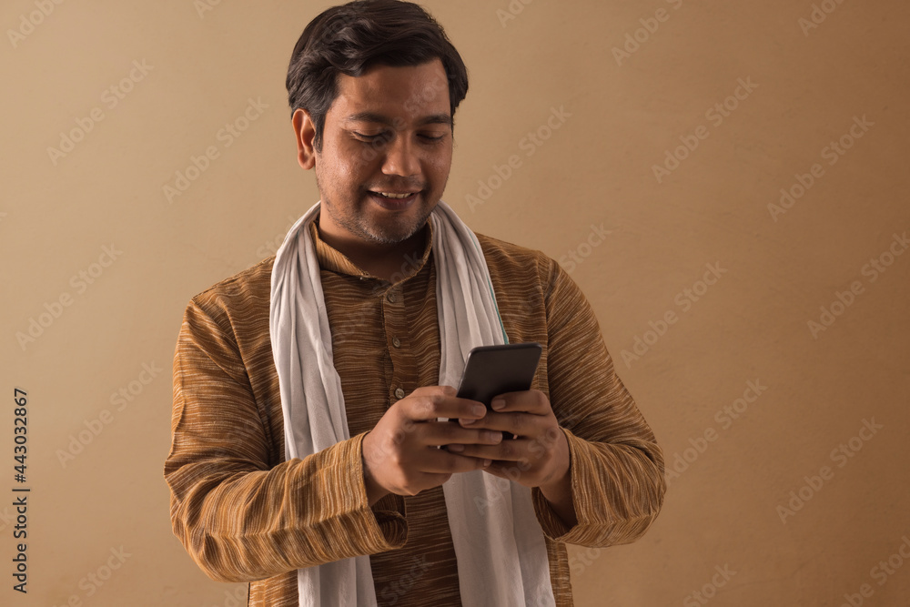 A RURAL MAN HAPPILY USING MOBILE PHONE A RURAL MAN HAPPILY USING MOBILE PHONE