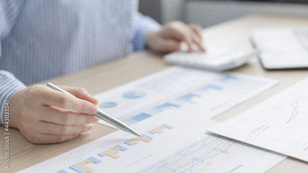 Asian business women are analyzing graphs, financial statistics and calculating corporate returns in private offices, Market research reports and income statistics, Financial and Accounting concept. Asian business women are analyzing graphs, financial statistics and calculating corporate returns in private offices, Market research reports and income statistics, Financial and Accounting concept.