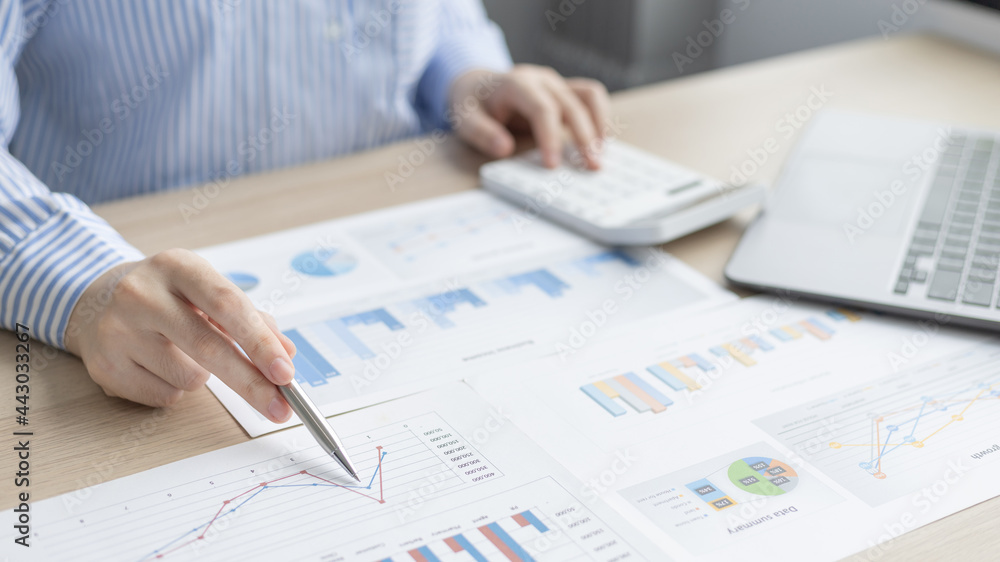 Asian business women are analyzing graphs, financial statistics and calculating corporate returns in private offices, Market research reports and income statistics, Financial and Accounting concept. Asian business women are analyzing graphs, financial statistics and calculating corporate returns in private offices, Market research reports and income statistics, Financial and Accounting concept.