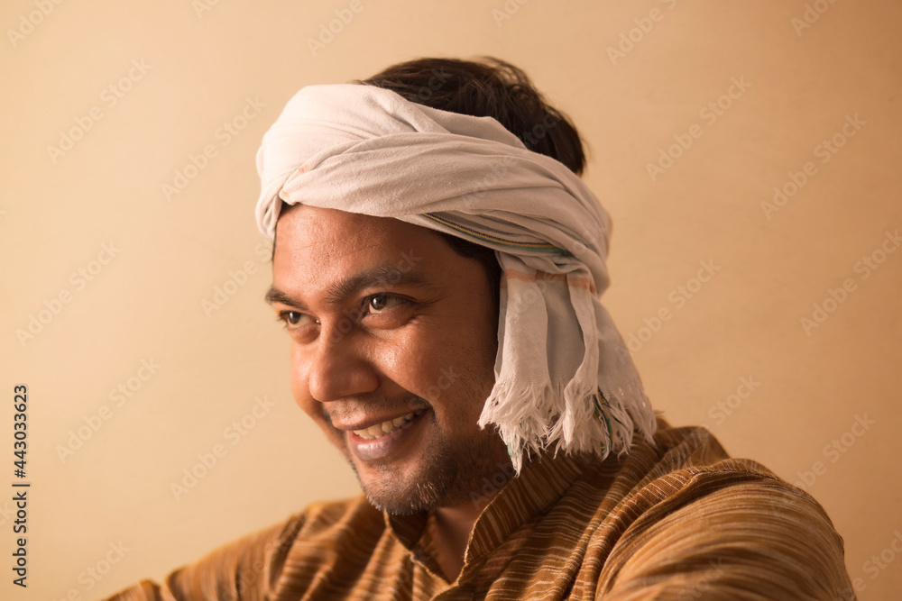 A HAPPY TURBANED MAN LOOKING ABOVE AND SMILING A HAPPY TURBANED MAN LOOKING ABOVE AND SMILING