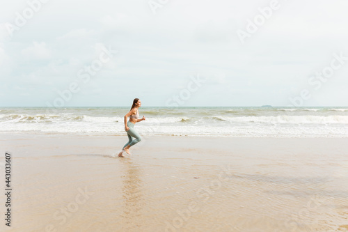 A caucasian woman runner in sportswear Outdoor jogging at the seaside.
