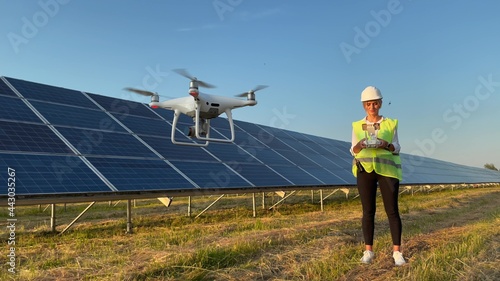 Technician and investor Using Infrared Drone Technology to Inspect Solar Panels and Wind Turbines in Solar cell Farm, Solar cells will be an important renewable energy of the future