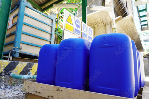 Blue plastic barrels on pallet in a chemical plant