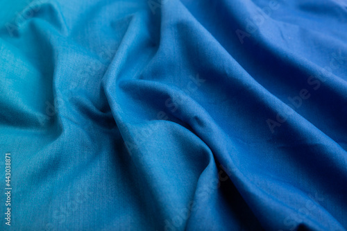 Fragment of cotton blue tissue. Side view, natural textile background.