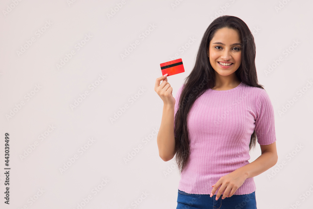 A TEENAGER STANDING IN FRONT OF CAMERA SHOWING DEBIT CARD A TEENAGER STANDING IN FRONT OF CAMERA SHOWING DEBIT CARD