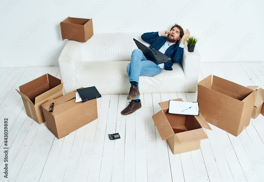 business man on the couch with boxes transporting things new place of work business man on the couch with boxes transporting things new place of work