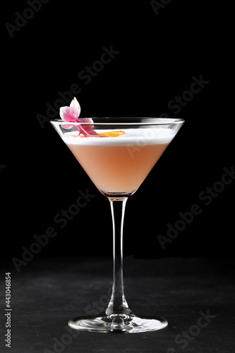 Whiskey sour cocktail in a glass on a black background