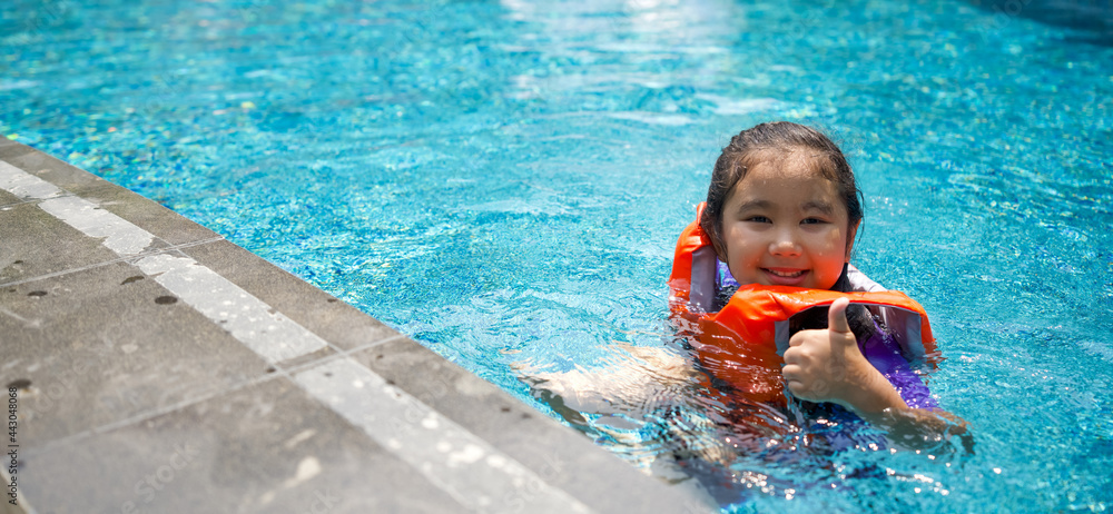 Fotografie Asian child playing in the pool