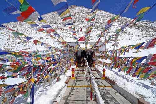 Tibetan flag on the highest road snow mountain is a Buddhist flag religion at Leh Ladakh , Jammu and Kashmir , India-hikes to epic mountain photo