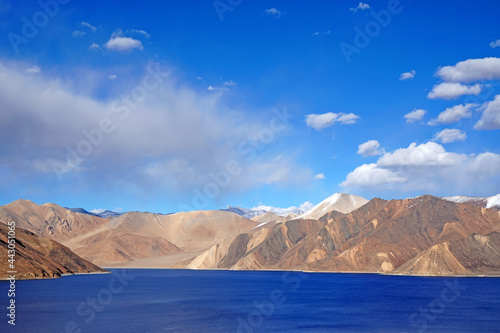 Landscape Lake Nature Scene of Pangong tso or Pangong Lake with Snow mountain background is best famous destination at Leh Ladakh ,Jammu and Kashmir , India - Blue nature travel Background - travel