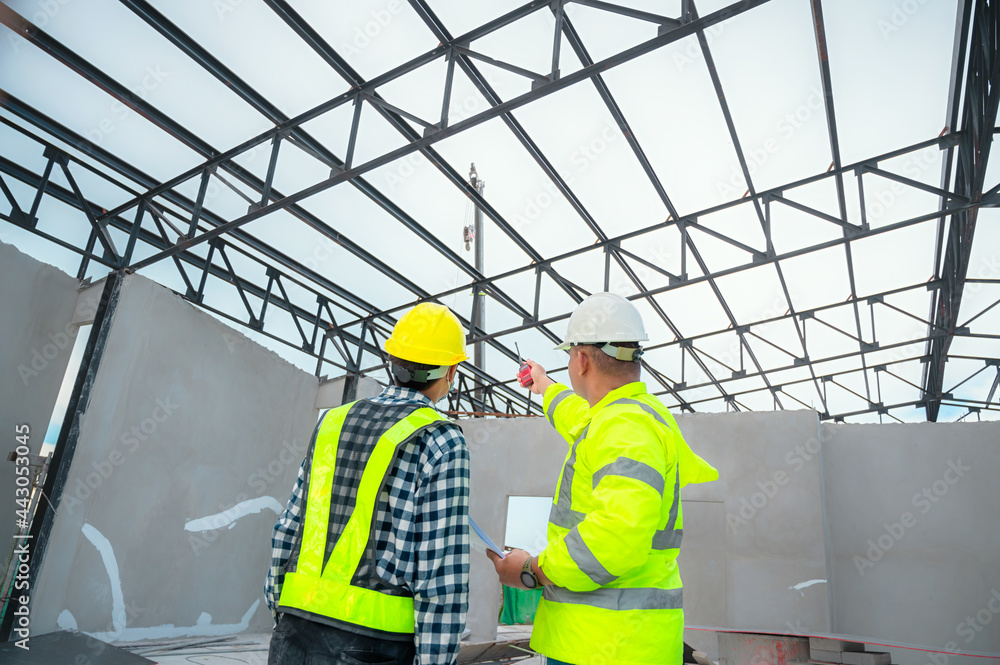 Civil engineer inspect structure at construction site against blueprint, Building inspectors jointly inspect the building structure with civil engineer. Civil engineer hold blueprint inspect building. Civil engineer inspect structure at construction site against blueprint, Building inspectors jointly inspect the building structure with civil engineer. Civil engineer hold blueprint inspect building.