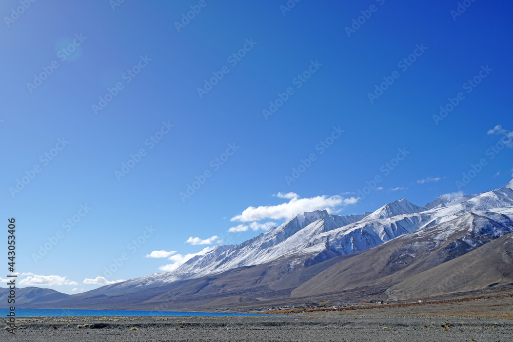 Landscape Nature Scene of Pangong tso or Pangong blue Lake with Snow mountain background at Leh Ladakh ,Jammu and Kashmir , India                                
