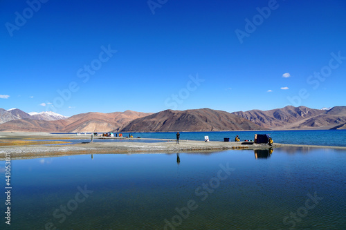 Nature Scene of Landscape Pangong tso or Pangong blue Lake with mountain background at Leh Ladakh ,Jammu and Kashmir , India - Travel and sightseeing 