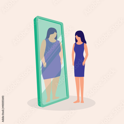 Young Skinny Woman Looking At Her Fat Reflection In Mirror. Anorexia Nervosa. Eating Disorder. photo