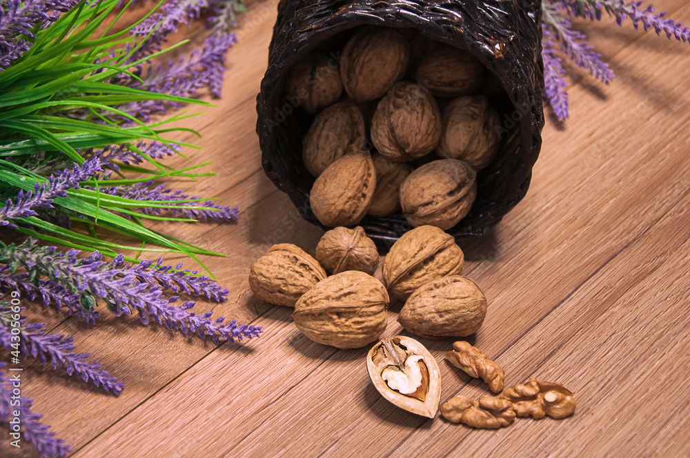 Walnuts in a wicker basket, lavender flowers. Healthy eating