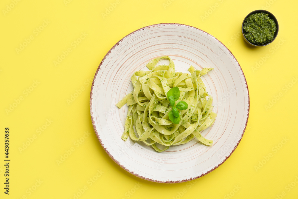 Plate with tasty pesto pasta on color background Plate with tasty pesto pasta on color background