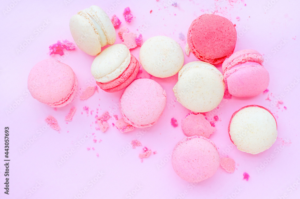 Group of mini sweet white and pink macaron on soft pink paper background Group of mini sweet white and pink macaron on soft pink paper background