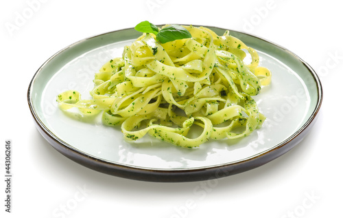 Plate with tasty pesto pasta on white background