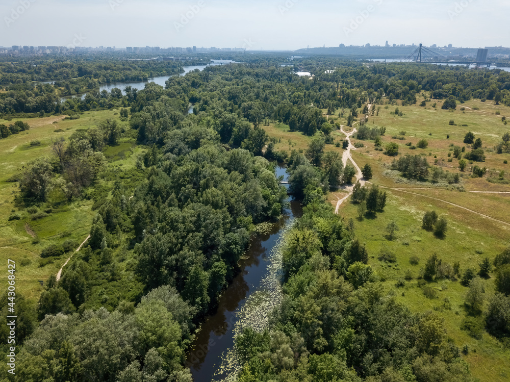 River among green trees in summer. Aerial drone view. River among green trees in summer. Aerial drone view.