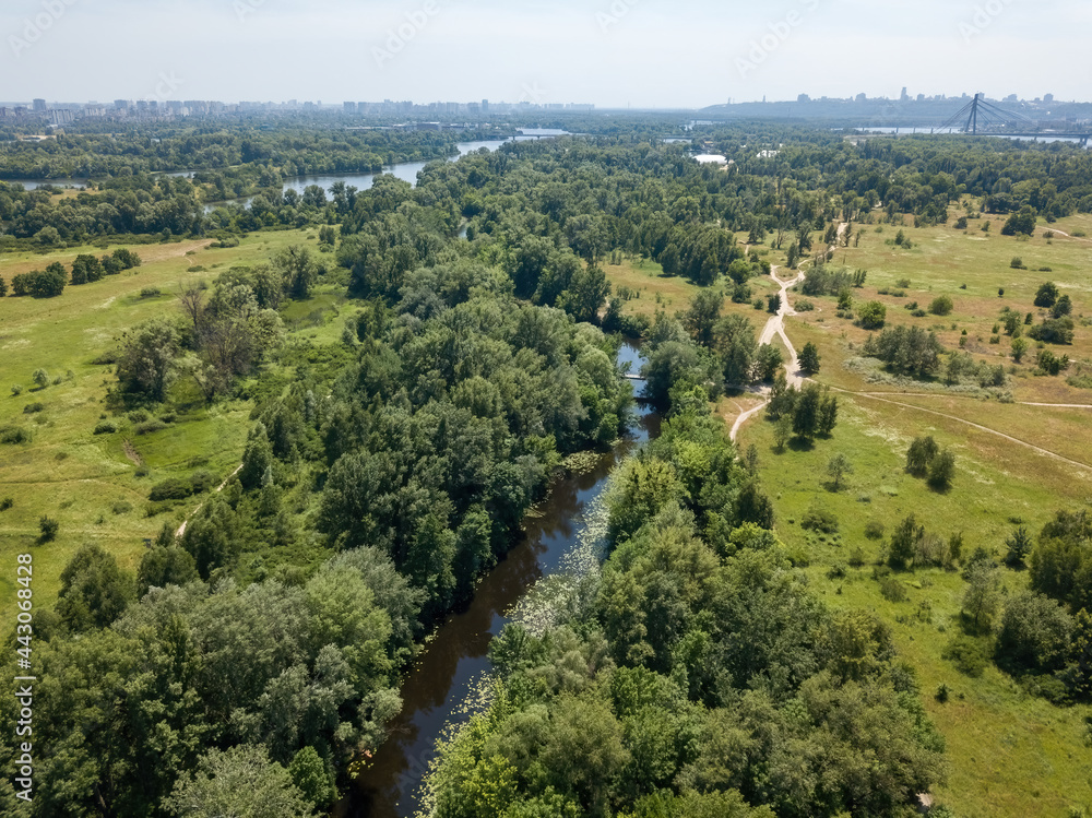 River among green trees in summer. Aerial drone view. River among green trees in summer. Aerial drone view.