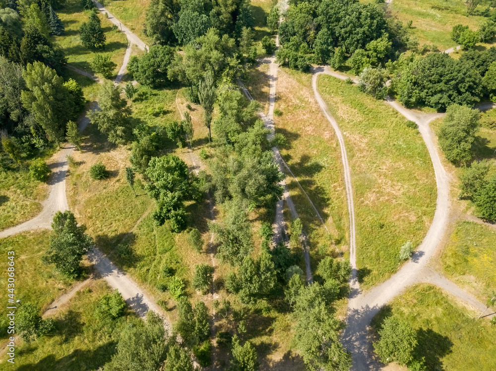 Dirt road in the park in summer. Aerial drone view. Dirt road in the park in summer. Aerial drone view.