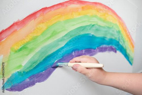 kid drawing colorful line art with paints rainbow