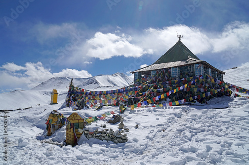 Landscape traditional pavilion with tibetan flag on white Snow mountain  at  Taglang La or Tanglang La pass Leh Ladakh ,Jammu and Kashmir , India