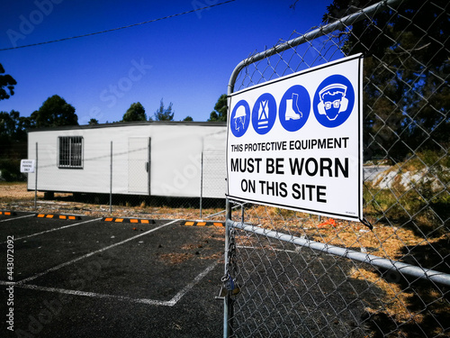 Warning sign construction site for must be worn this protective equipment on this site. photo