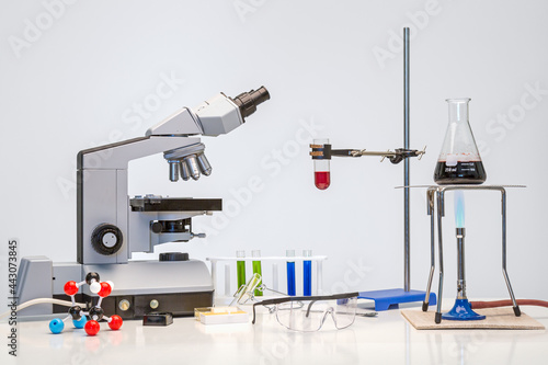 Science bench with microscope and chemicals photo