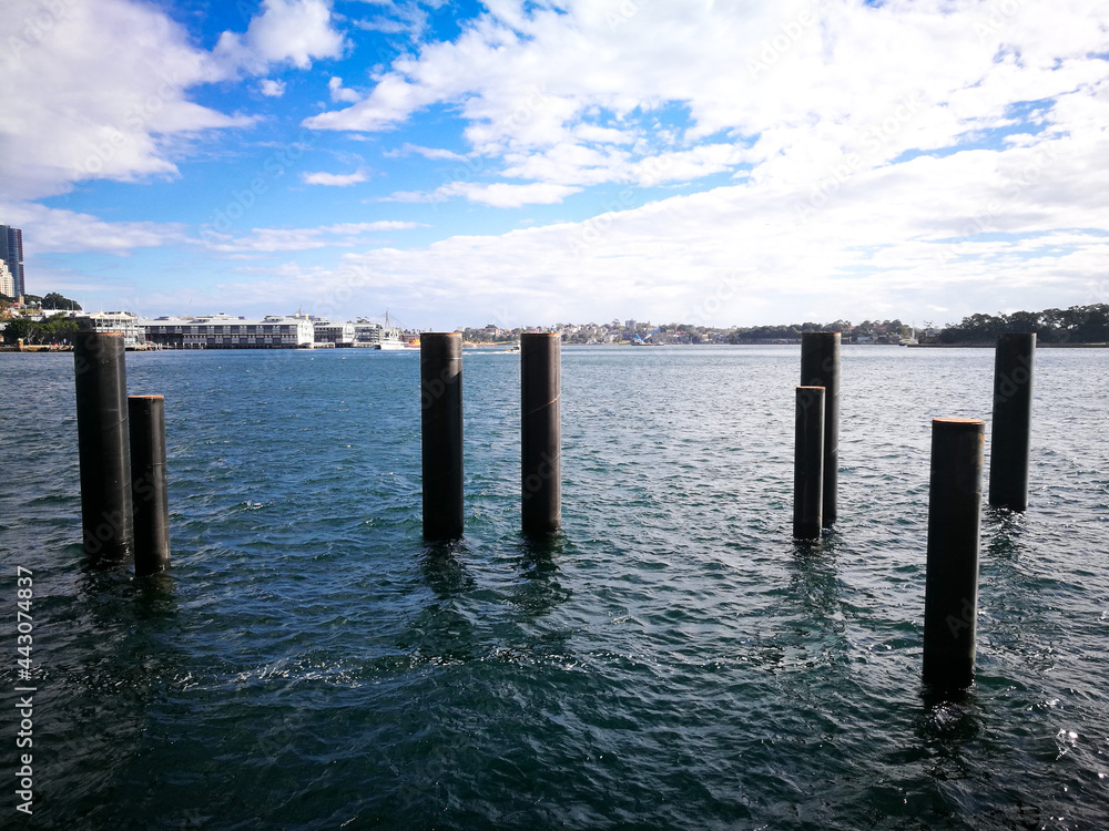 Black poles in an ocean for the beginning of construction.
Black poles in an ocean for the beginning of construction.