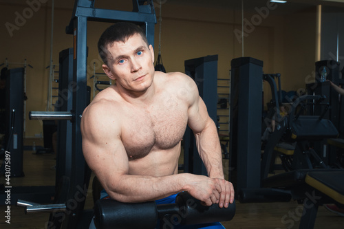 Training in the gym, muscular man. Sexy guy
