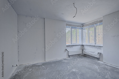 Unfinished room of inside house under construction. Construction building industry new home construction interior drywall tape. Building construction gypsum plaster walls