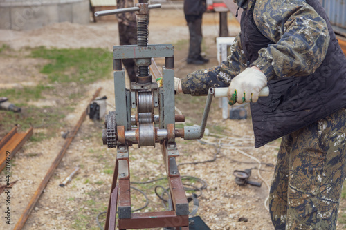 Fototapeta Naklejka Na Ścianę i Meble -  Workers bend metal in a pipe bender.