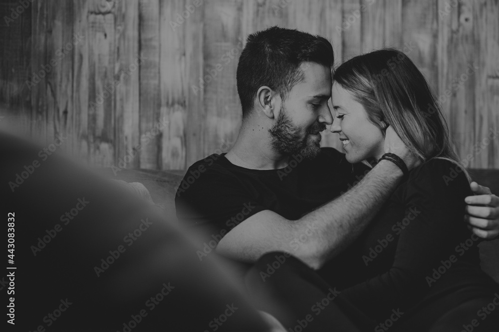 Happy couple hugging on sofa Happy couple hugging on sofa