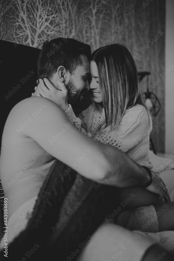 Happy couple hugging on bed Happy couple hugging on bed
