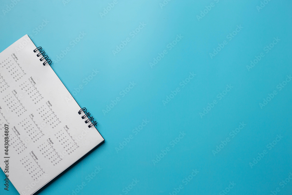 Calendar on solid blue background with copy space, business meeting schedule, travel planning or project milestone and reminder concept. Calendar on solid blue background with copy space, business meeting schedule, travel planning or project milestone and reminder concept.