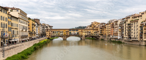 Ponte Vecchio, old bridge on the river in Florence with dramatic sky