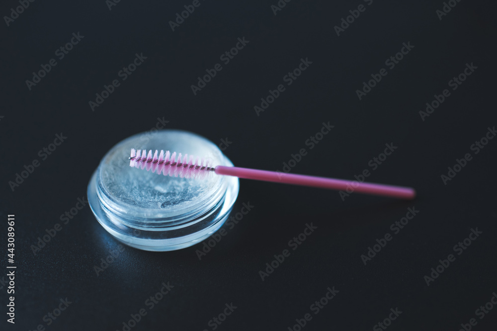 Eye brows gel glue with pink brush closeup. Make up cosmetic product. Eye brows gel glue with pink brush closeup. Make up cosmetic product.