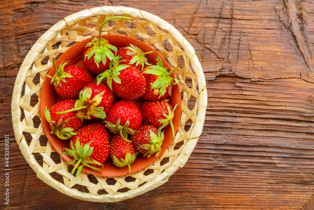 Fresh large strawberries on a wooden table in a wicker dish. Fresh large strawberries on a wooden table in a wicker dish.