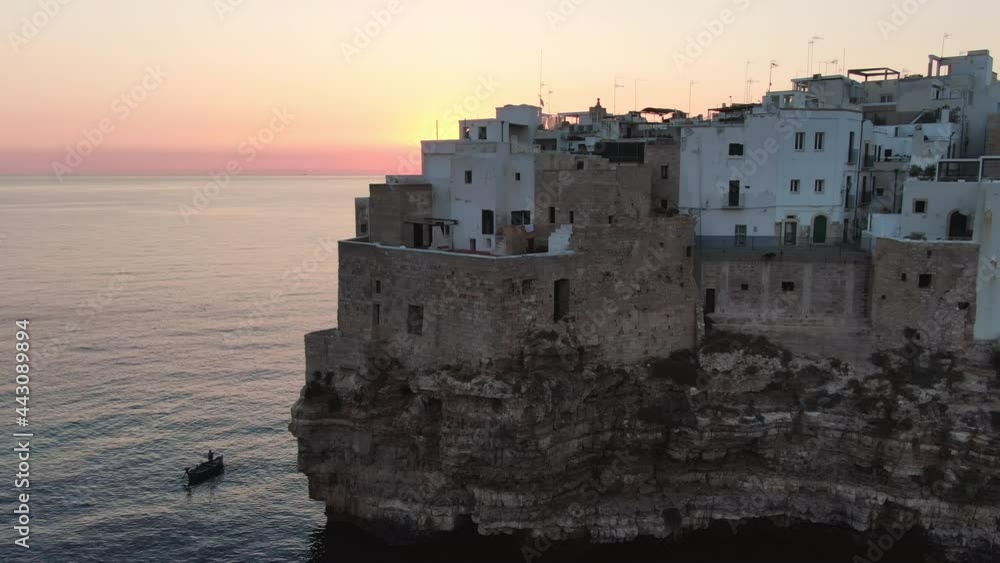 polignano a mare city aerial view of fisherman on the boat fishing at sunrise close to the village,puglia italy apulia polignano a mare city aerial view of fisherman on the boat fishing at sunrise close to the village,puglia italy apulia