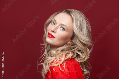 Portrait of beautiful happy woman with blonde hair and makeup. Beautiful blonde lady with bright red lipstick on her lips. © artmim
