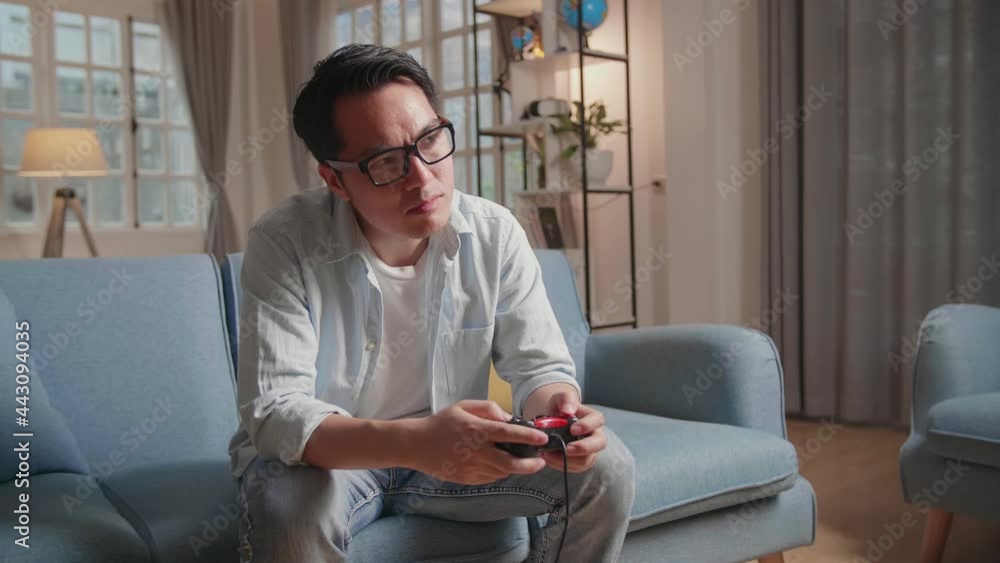 Bored Asian Man Using Joystick Playing A Game At Home
Bored Asian Man Using Joystick Playing A Game At Home