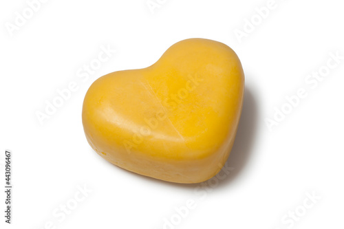 Single heart shaped Gouda cheese isolated on white background