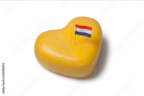 Heart shaped Gouda cheese with Dutch flag isolated on white background