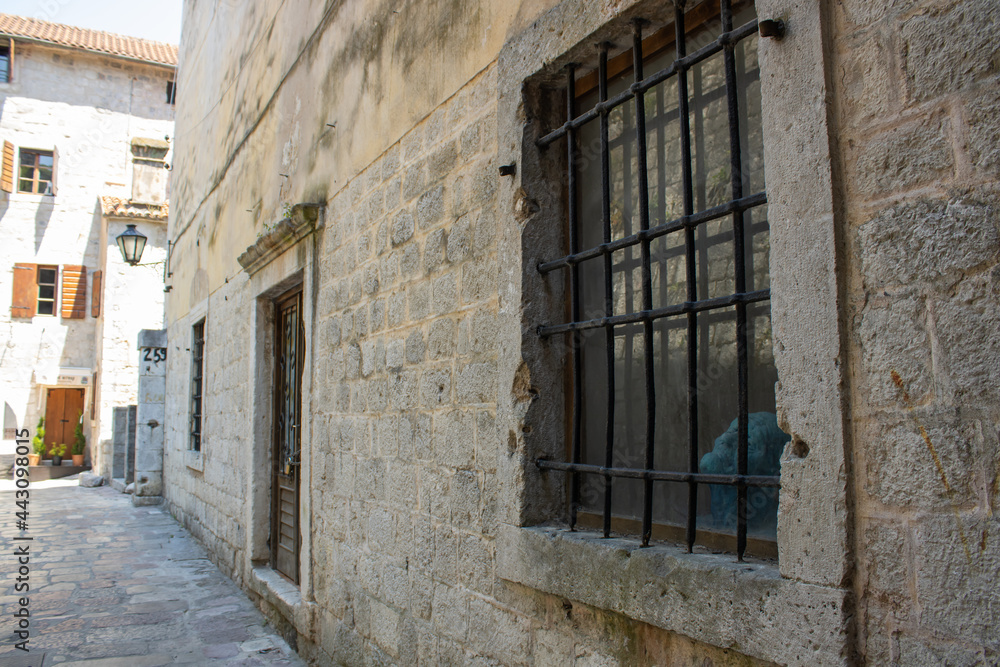 Charming streets of medieval сity. Details of architecture in the old town. Travel Kotor Montenegro. Vintage background.