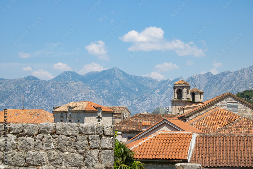 Old town of Kotor Montenegro on the background of mountains and blue sky. The bright beautiful landscape of  against the background of mountains in the summer on a clear day.