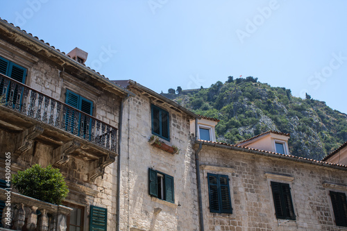Old town of Kotor Montenegro on the background of mountains and blue sky. The bright beautiful landscape of against the background of mountains in the summer on a clear day