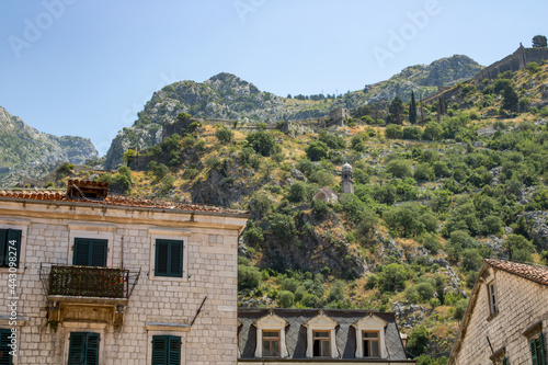 Old town of Kotor Montenegro on the background of mountains and blue sky. The bright beautiful landscape of against the background of mountains in the summer on a clear day