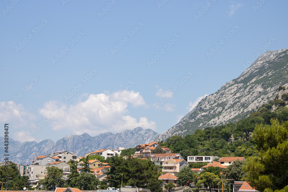 Obraz premium Old town of Kotor Montenegro on the mountains and blue sky background. The bright beautiful landscape in the summer on a clear day.